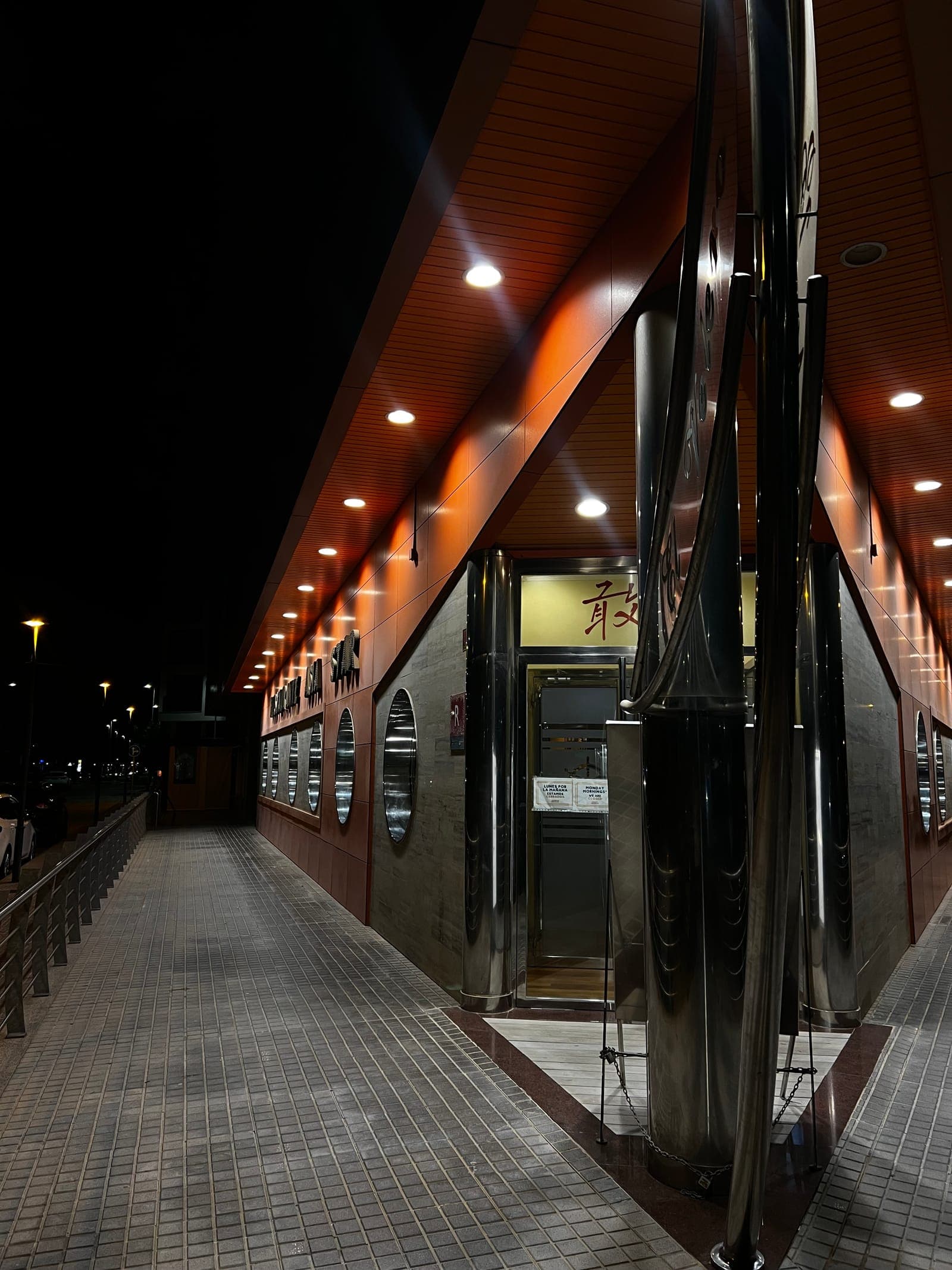 The lit entrance to Restaurante Asia Star at night, seen from the pavement